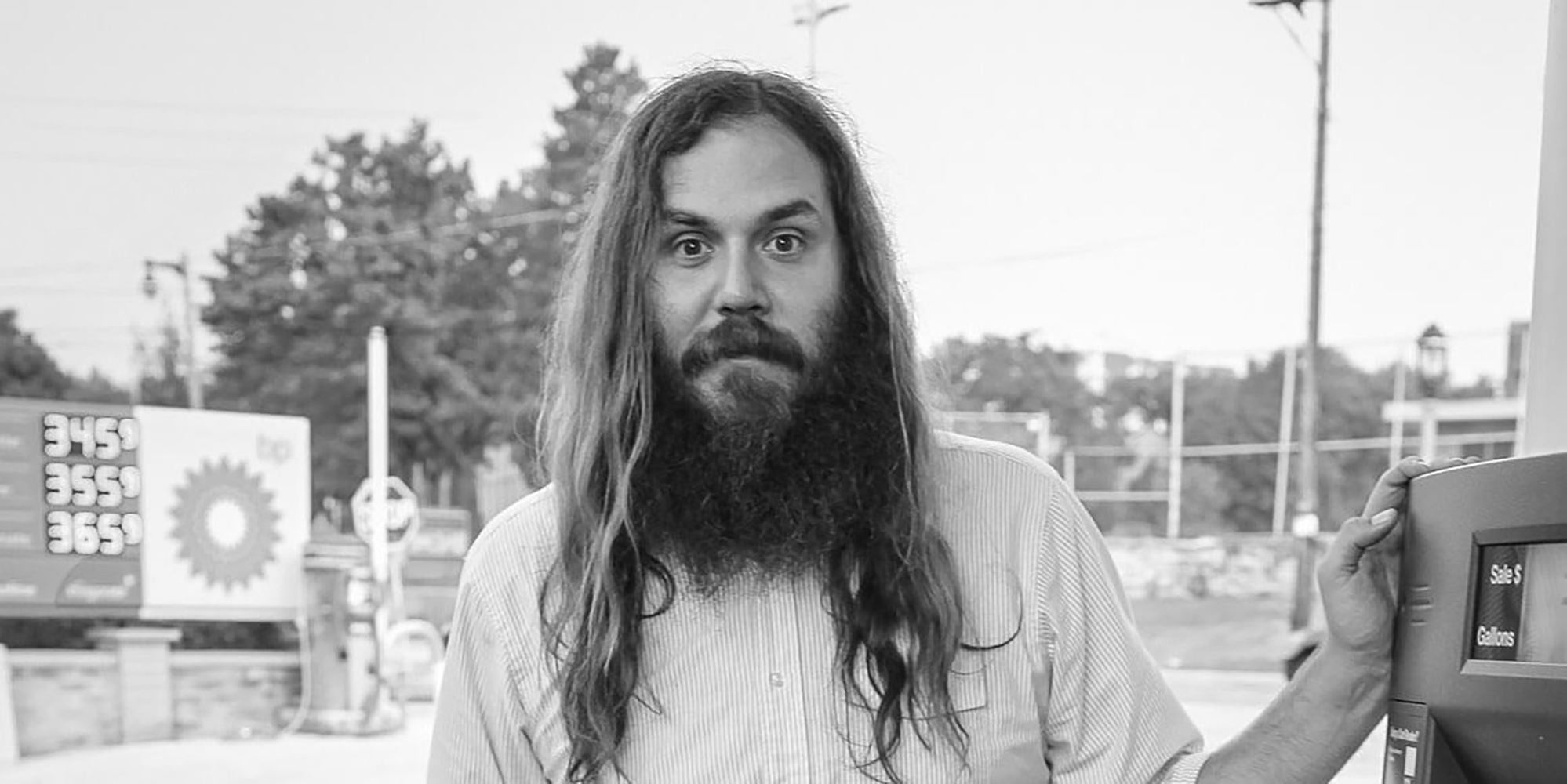 Milwaukee Film Cinema Operations Director Petey Balestrieri standing near a gas station pump.