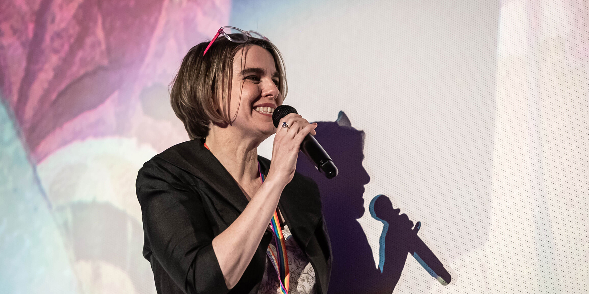 Milwaukee Film Executive Director Susan Kerns speaking on stage at a film screening.