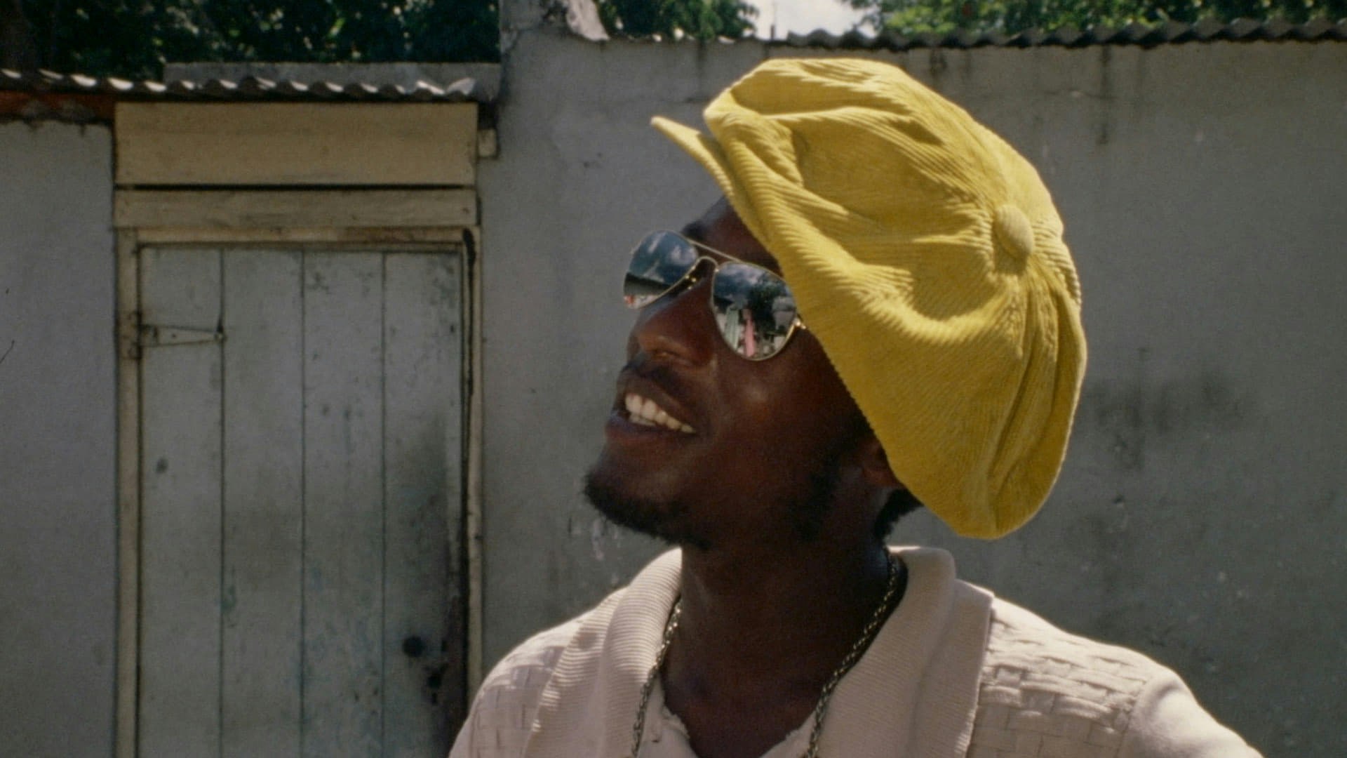 Still from The Harder They Come showing Jimmy Cliff in a cool yellow hat.