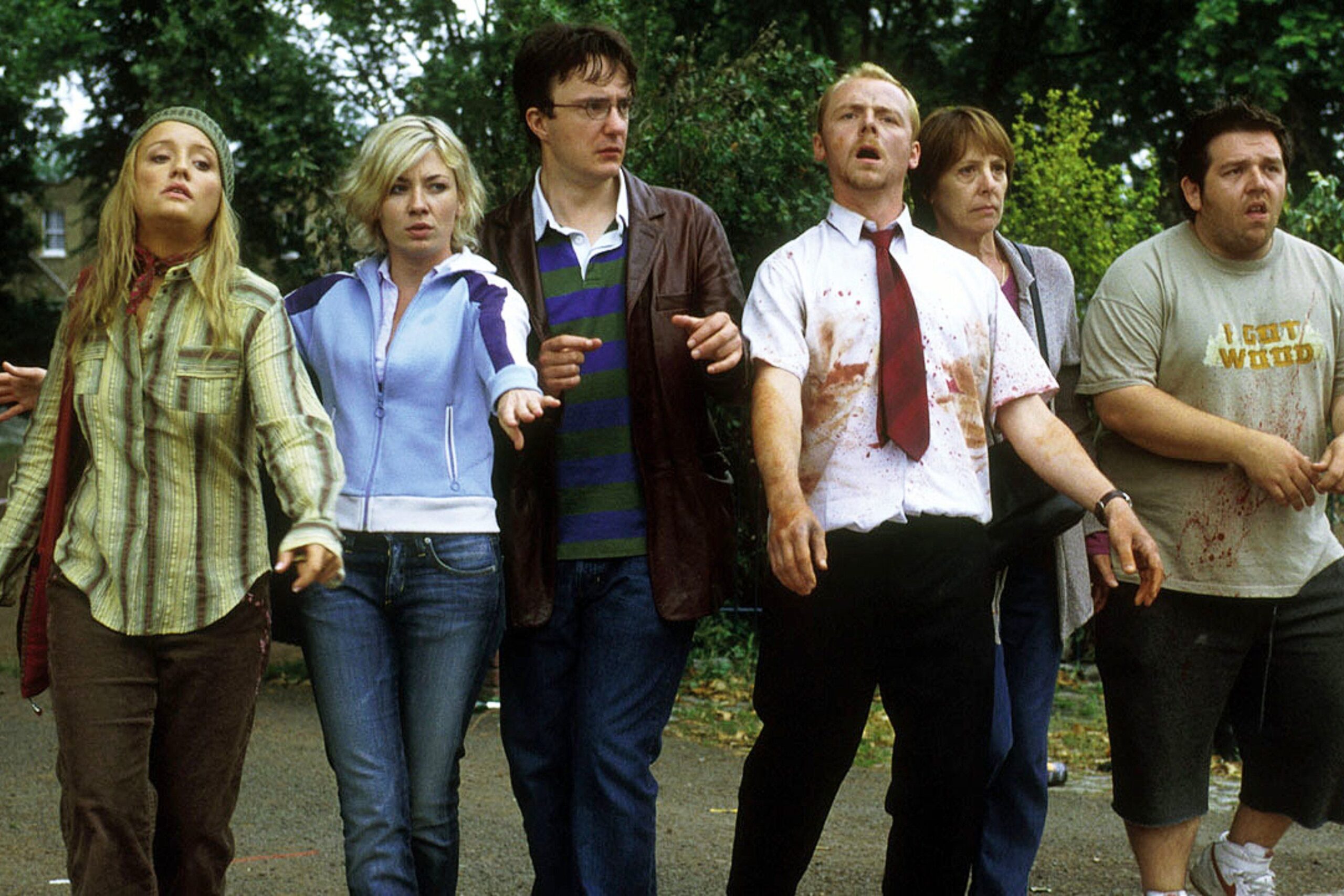 Film Still from Shaun of the Dead. The ensemble cast in a line walking forward.