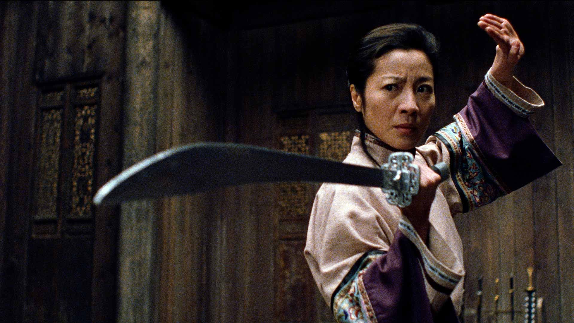 Actress Michelle Yeoh brandishes a sword in a still from the movie CROUCHING TIGER, HIDDEN DRAGON