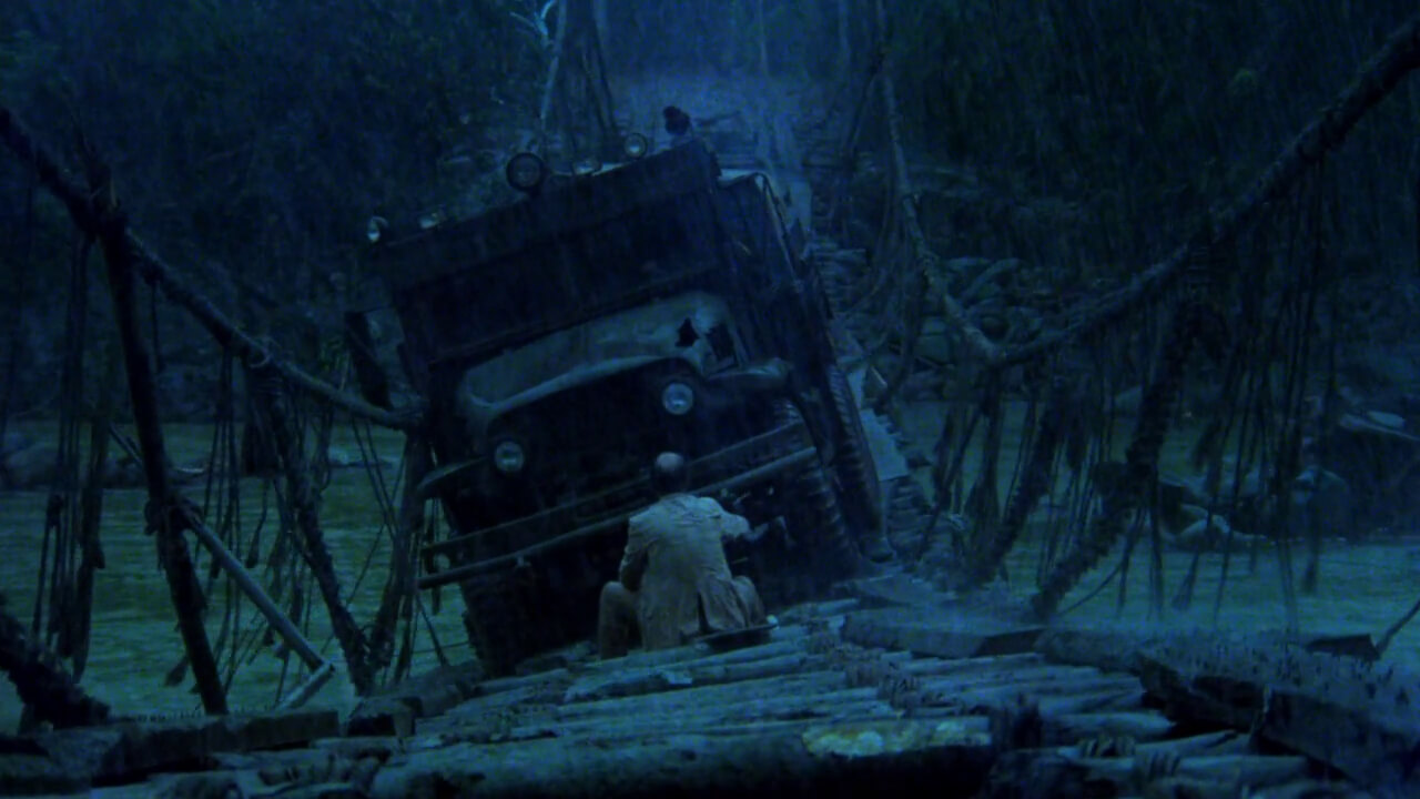 Sorcerer Film Still A truck falls as it drive across a wooden bridge.