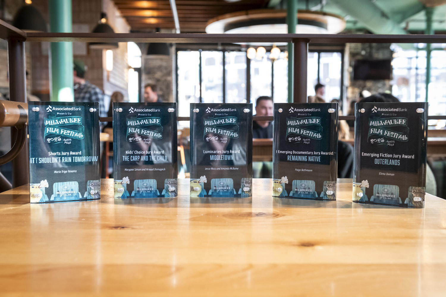 A photo of several award statuettes