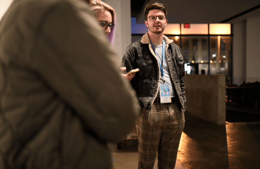 An intern standing in a gallery space