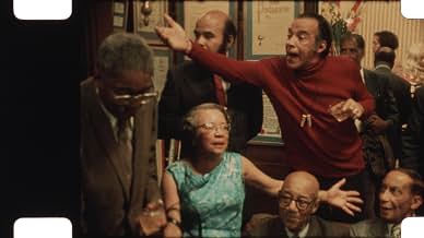 Scene from the documentary Once Upon a Time in Harlem featuring people in a crowded room circa the 1970s speaking passionately