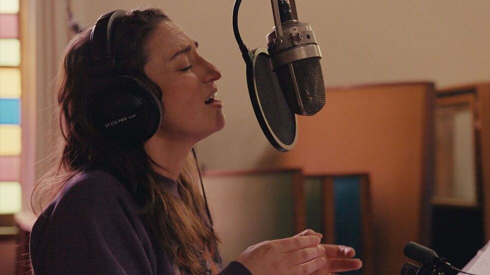 Still from the documentary Sara Bareilles: Good Grief, featuring recording artist Sara Bareilles singing into a studio microphone