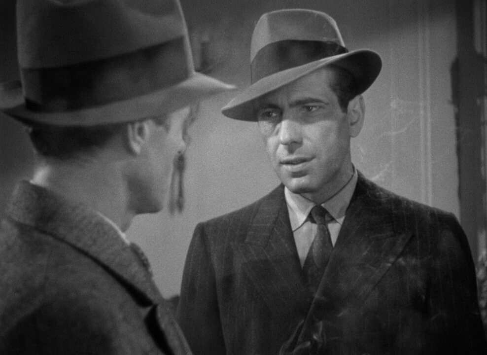 Maltese Falcon Film Still Black and White Two men in hats, one faces away and one faces towards the other