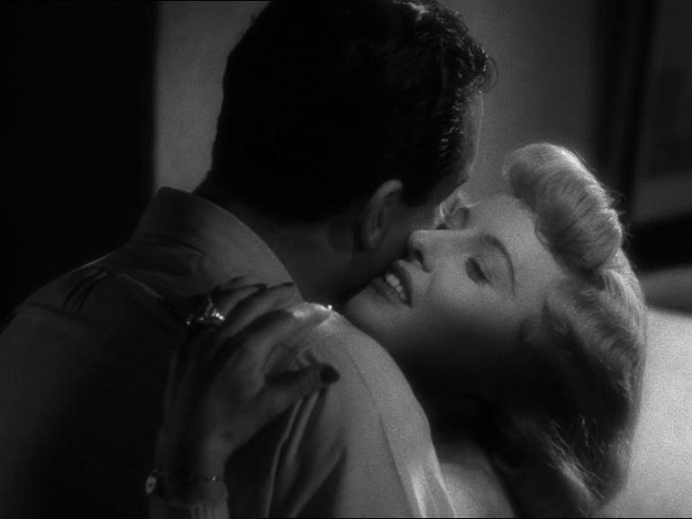 Double Indemnity Film Still Black and White the back of a mans head and the side of a womans face as they embrace in a hug Tight shot
