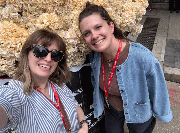 A photo of Cara and Kerstin in front of some flowers in Toronto